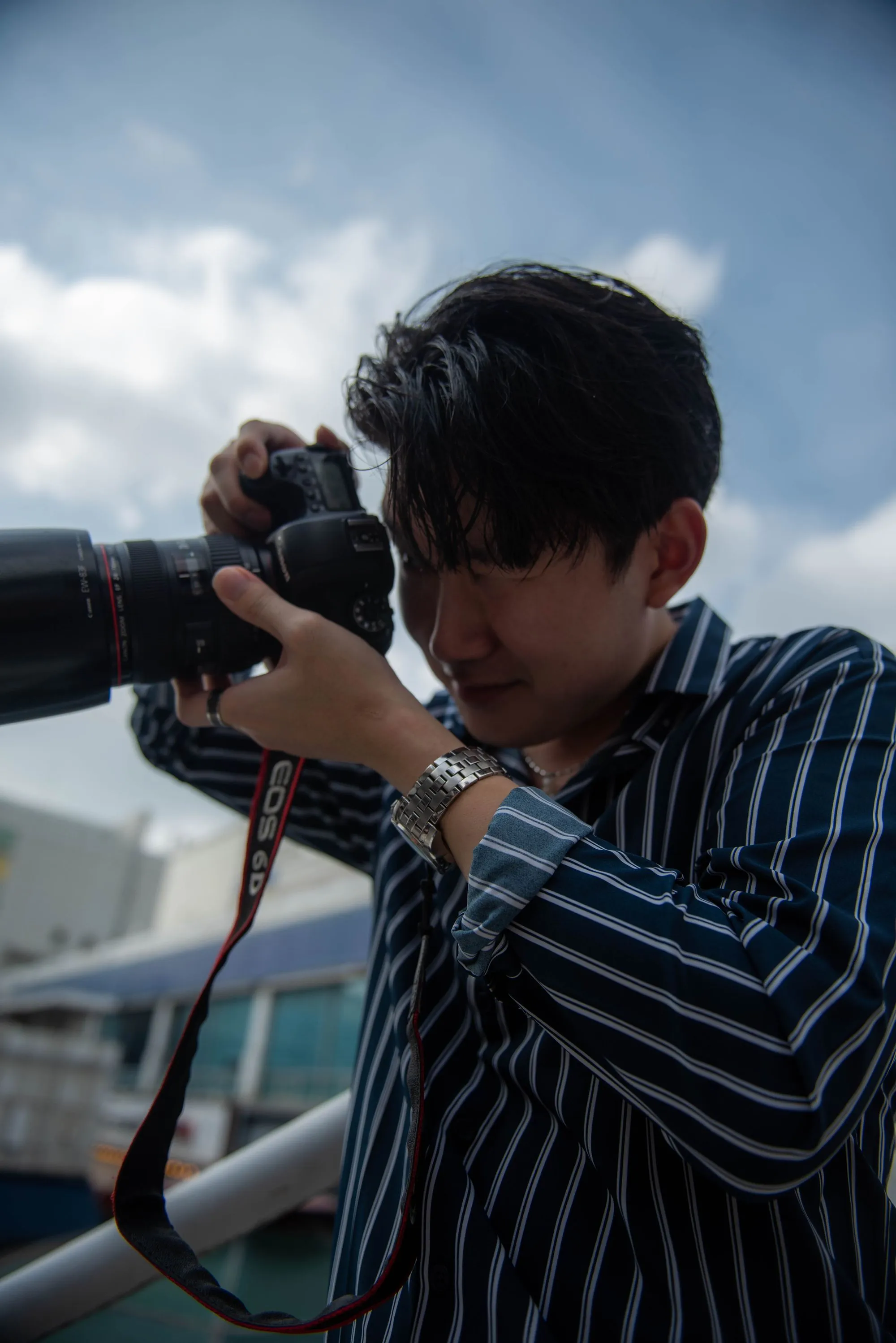 A PIN Studio photographer holding a camera.