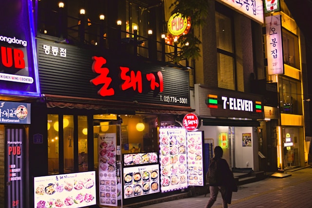 A Korean restaurant storefront with illuminated signs.