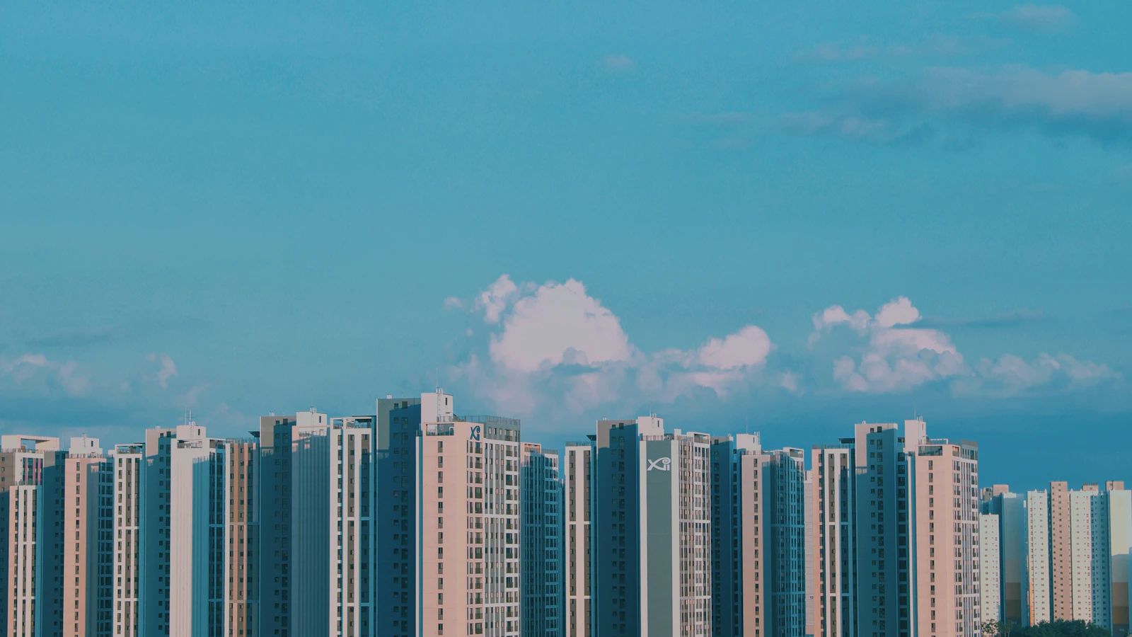 Apartment towers beneath a blue sky in Pyeongtaek, South Korea.