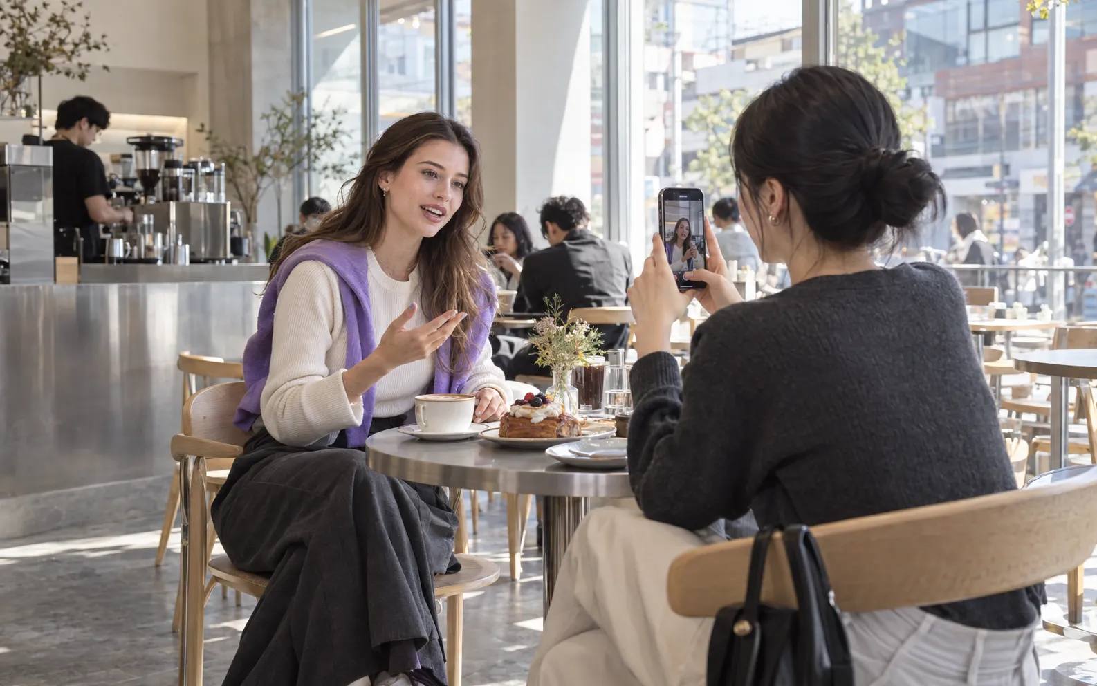A creator recording a café video with a collaborator.