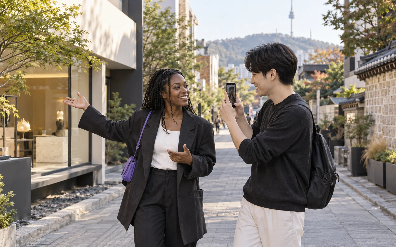 A creator recording a video with a collaborator on a Seoul street.