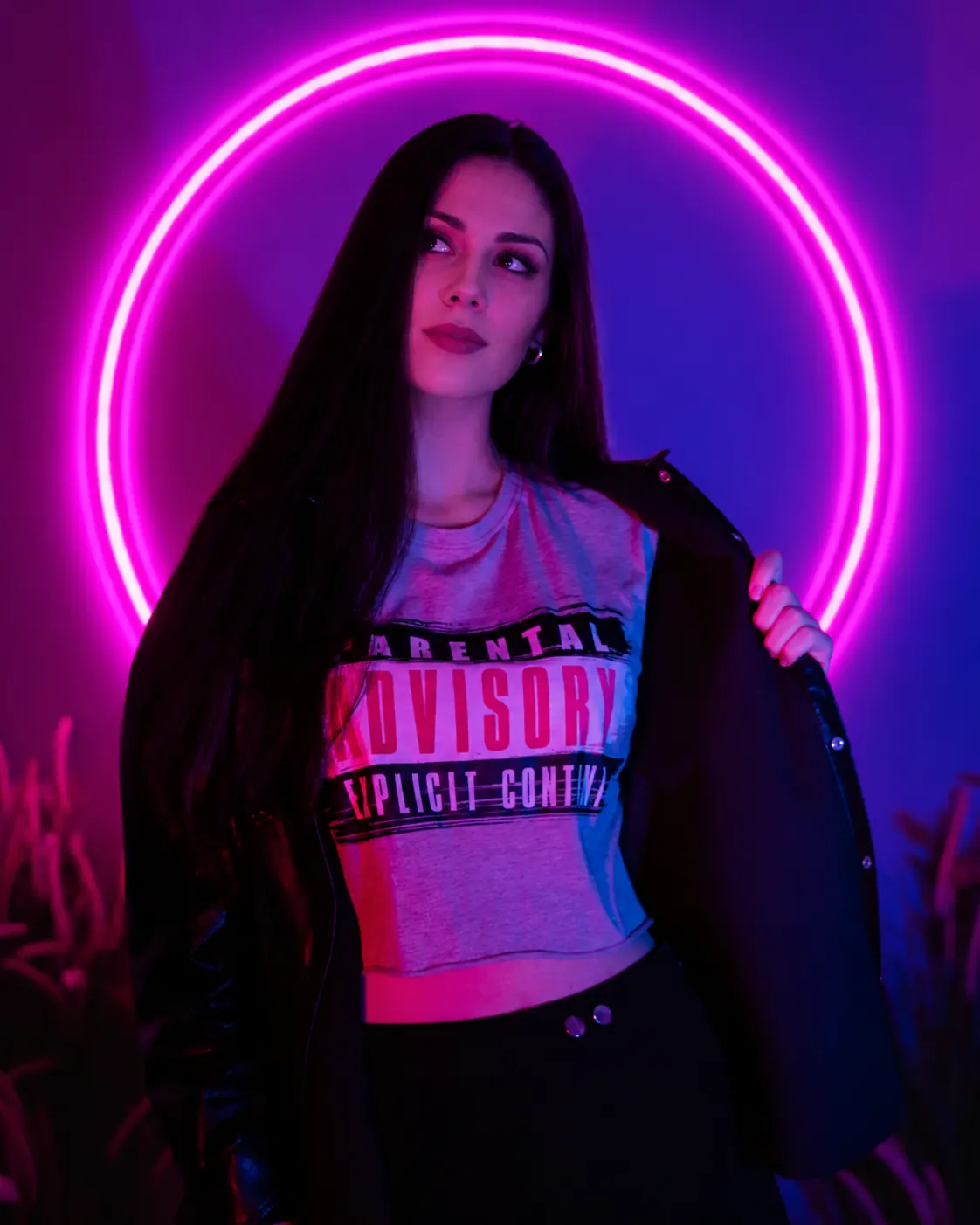 Original PIN Studio concept portrait of a woman framed by a pink neon circle. Her face has been replaced with an AI-generated identity.