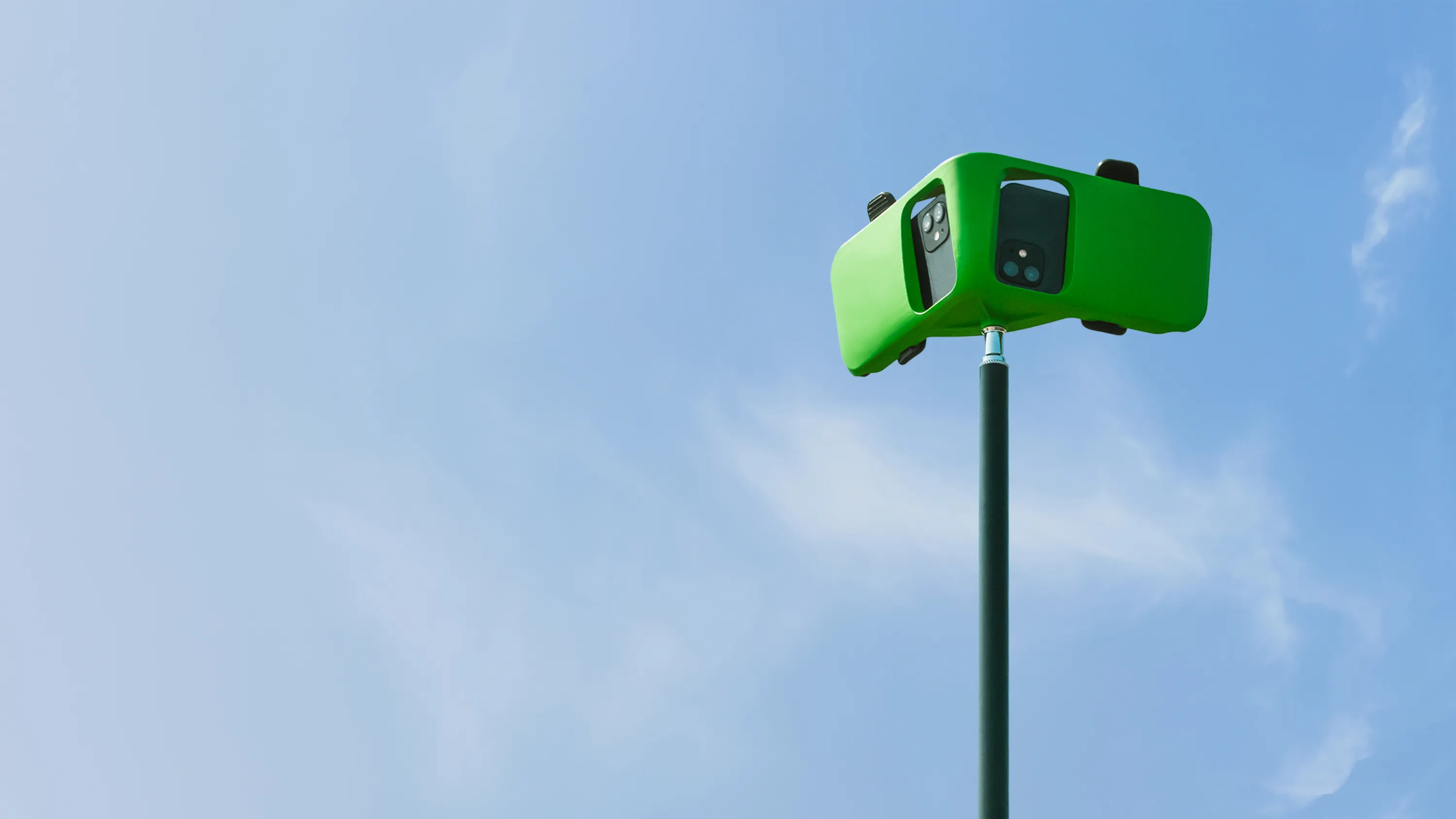 Veo Go camera mounted on a tripod against a bright blue sky.