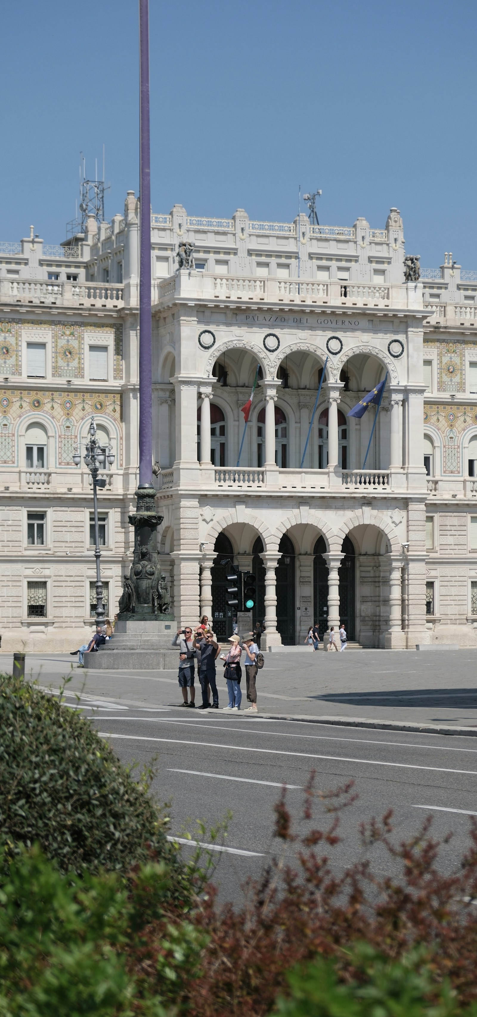 Group of residents standing in front of a city building, representing the diverse public served by municipal citizen services and AI agents.