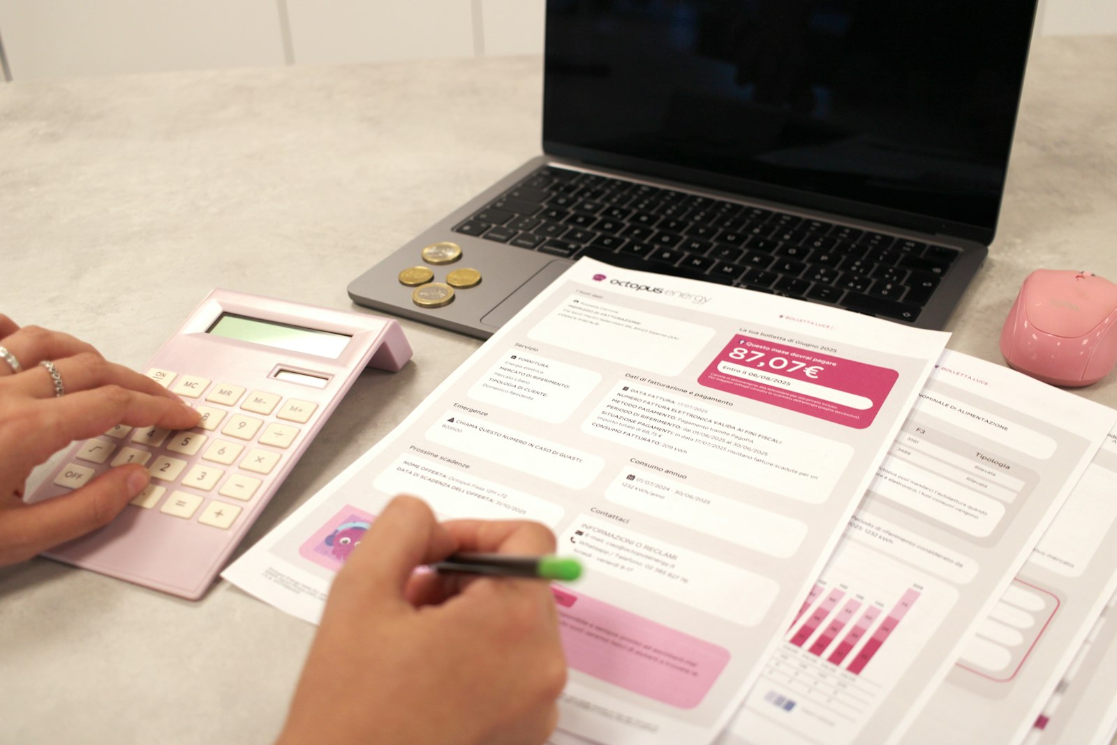 Hands reviewing printed financial documents and figures at a desk, illustrating manual account reconciliation work