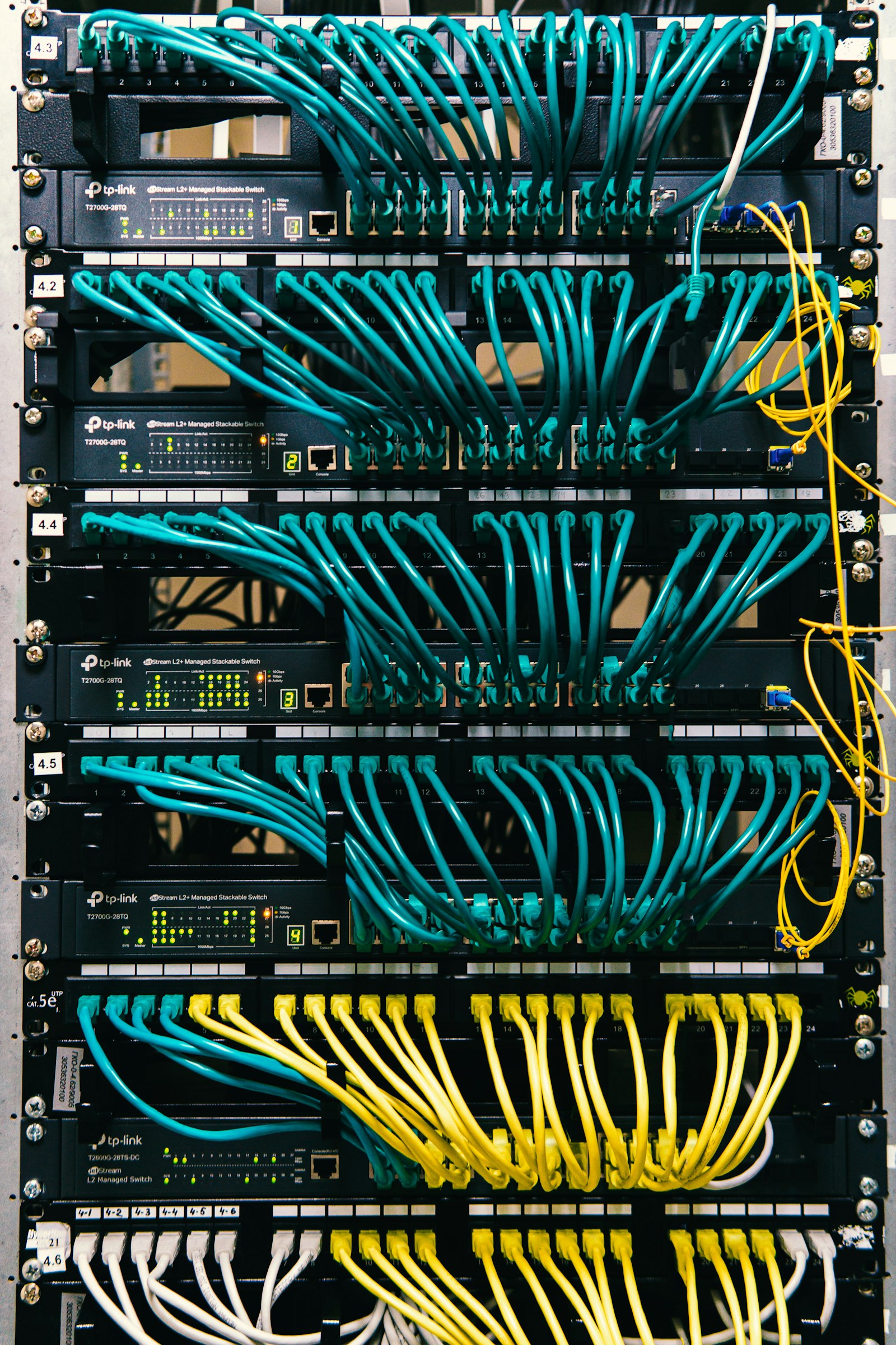 A rack of enterprise servers wired together in a data center, representing the complexity of an enterprise data migration