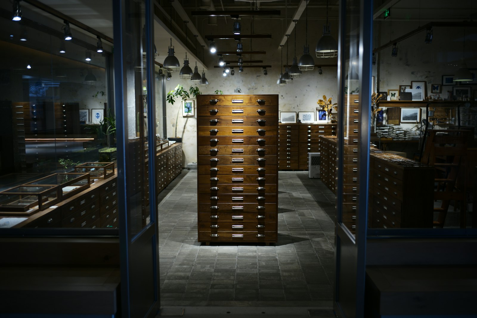 Rows of wooden filing cabinets in a government records office storing paper documents and archived case files