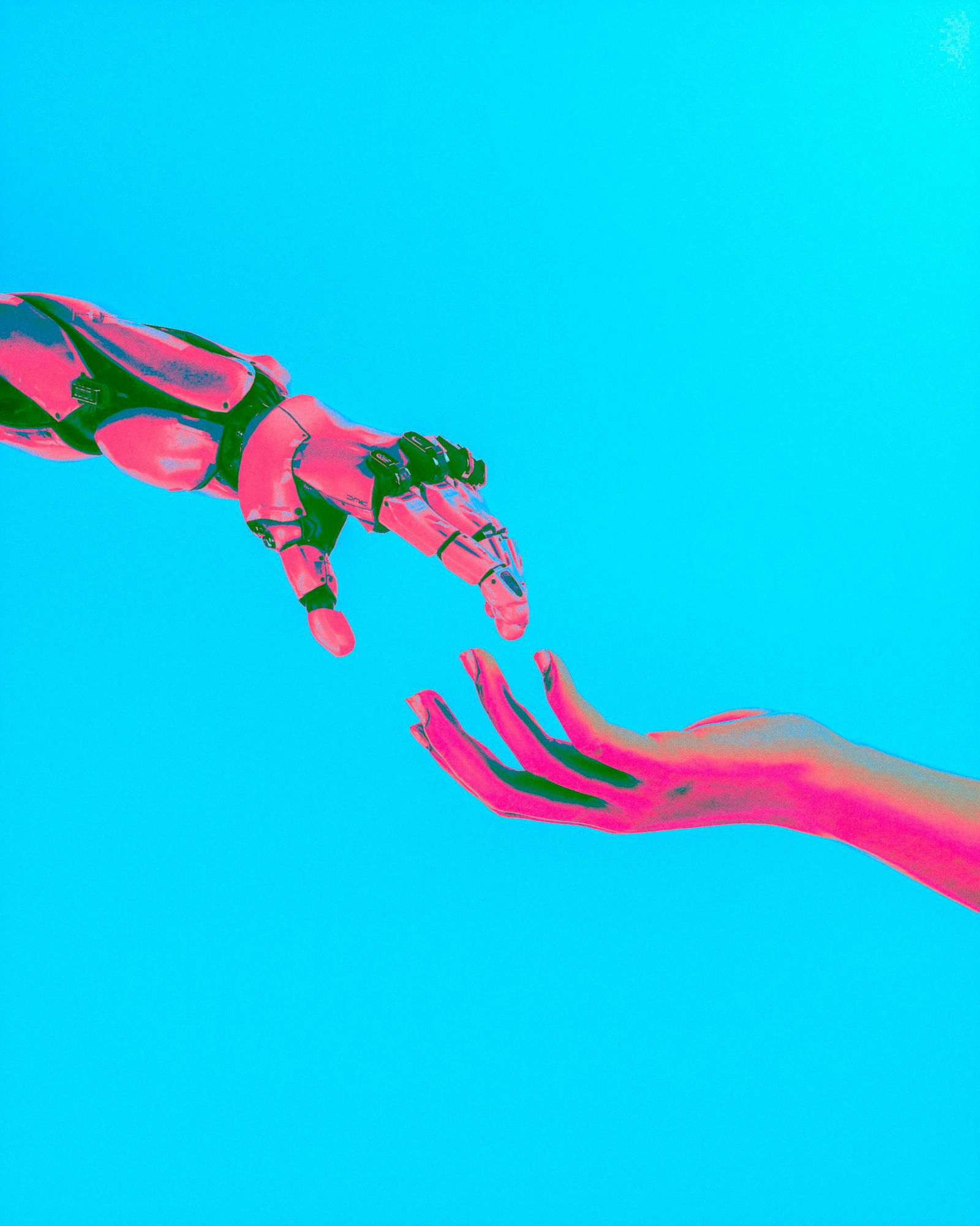 A robotic hand and a human hand reaching toward each other, representing AI agents and human copilots working together