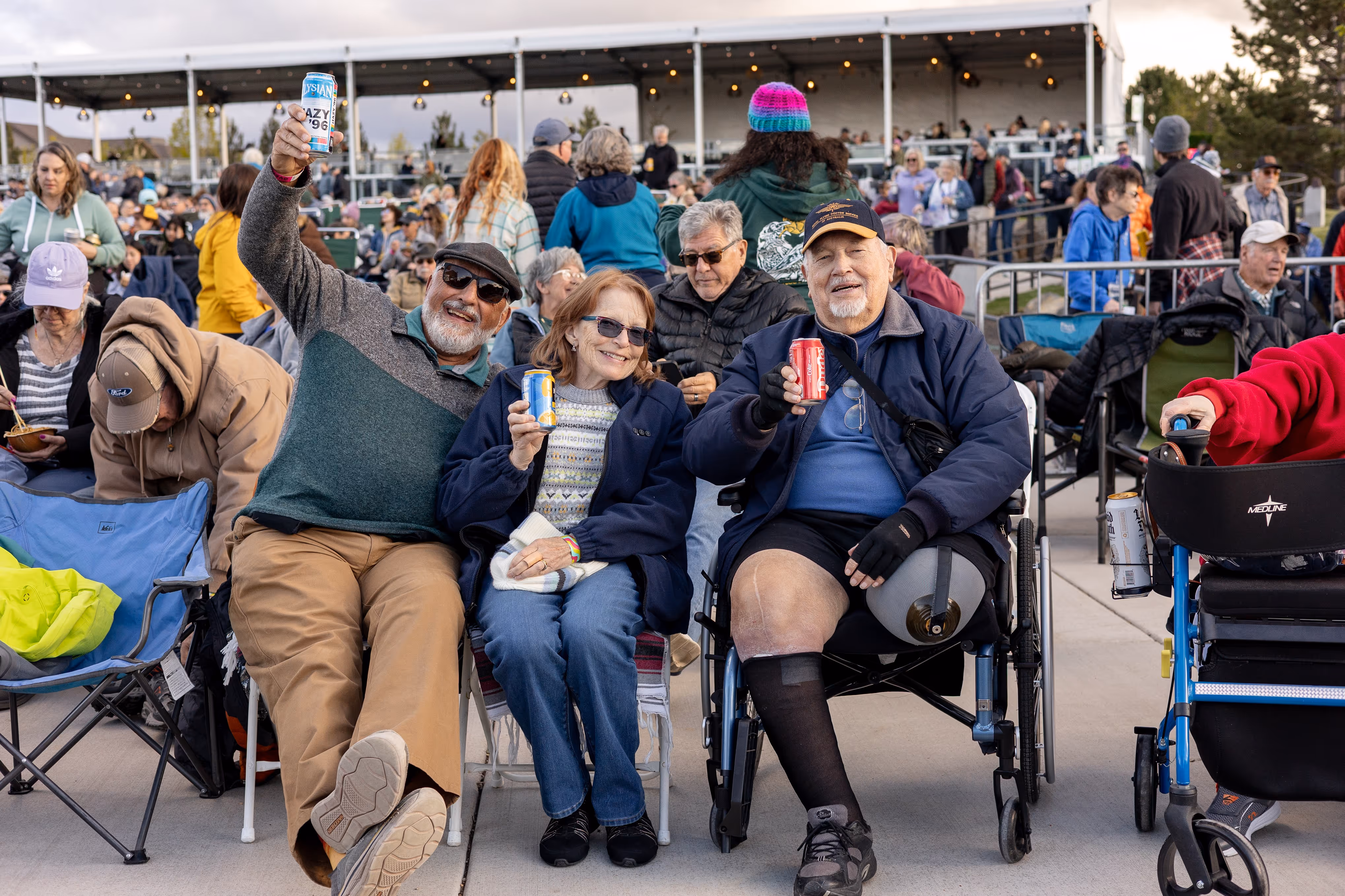 Two middle age men and one woman in the ADA section at Hayden Homes Amphitheater showcasing the enjoyable experience of a concert while in a wheelchair.