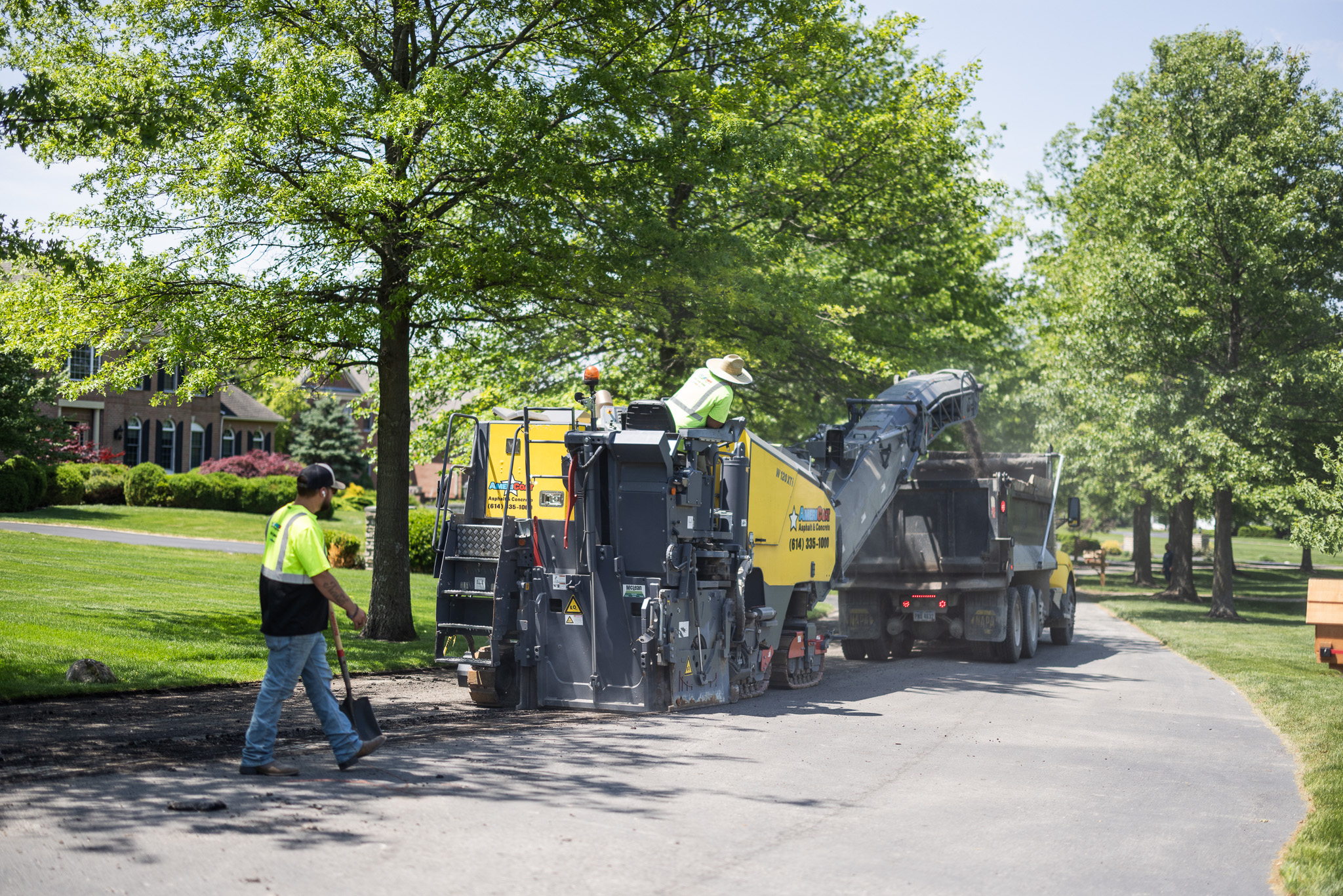 AmeriCoat crew operating asphalt milling machine on commercial street in Central Ohio