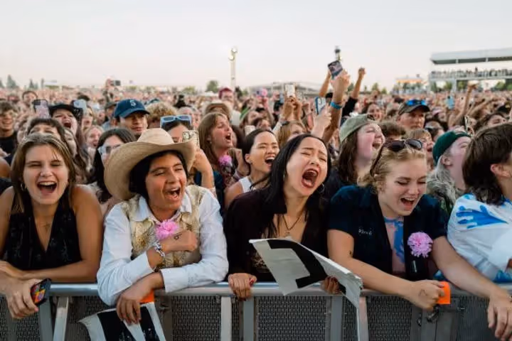 fans cheering their faces off at boygenius' concert at Hayden Homes Amphitheater