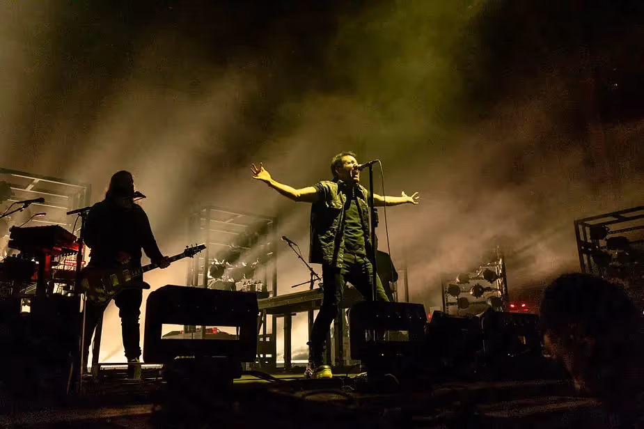 Trent Reznor of Nine Inch Nails singing into the microphone during 2022 concert