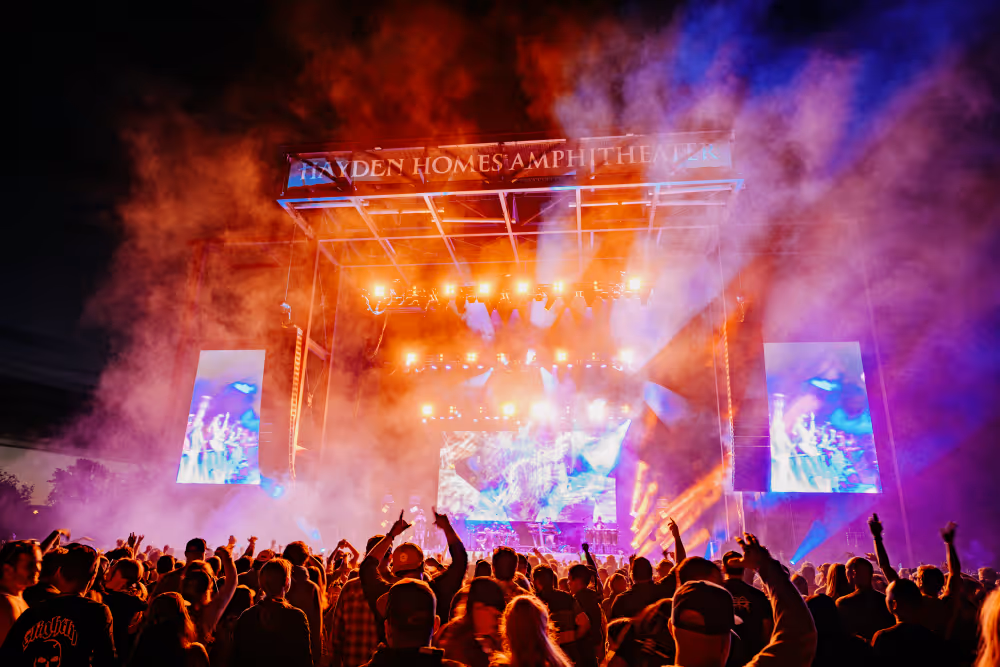 Stage lit up with red, blut and purple light enhanced by lasers and fog at the Slighty Stoopid concert at Hayden Homes Amphitheater in Bend, Oregon.