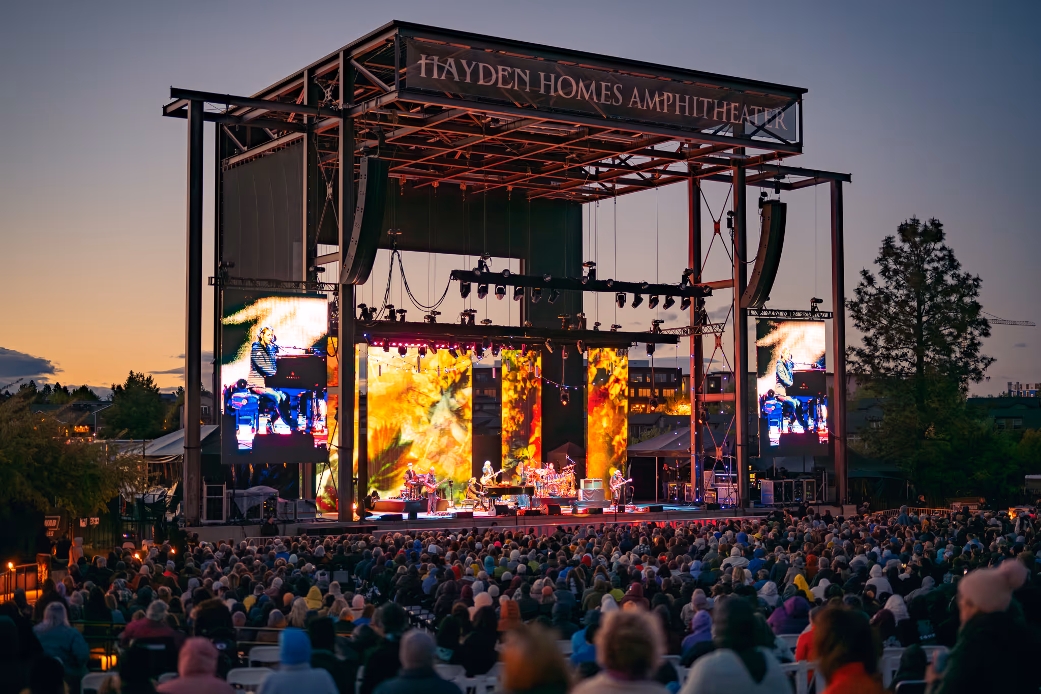 Sunny summer day in Bend, Oregon and full crowd at Hayden Homes Amphitheater cheering for the band.