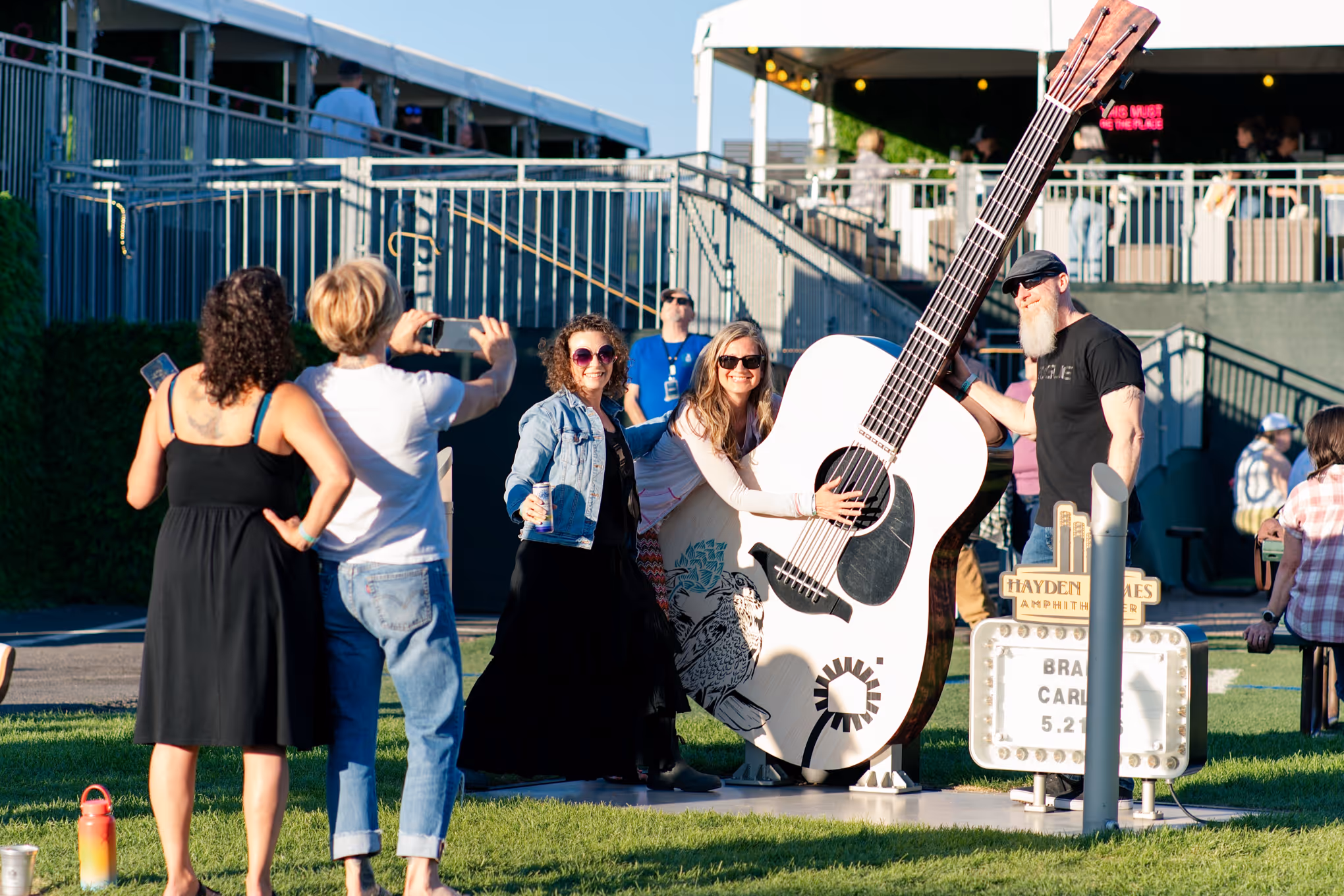 Fans pose in front of the selfie guitar at Hayden Homes Amphitheater in Bend, Oregon