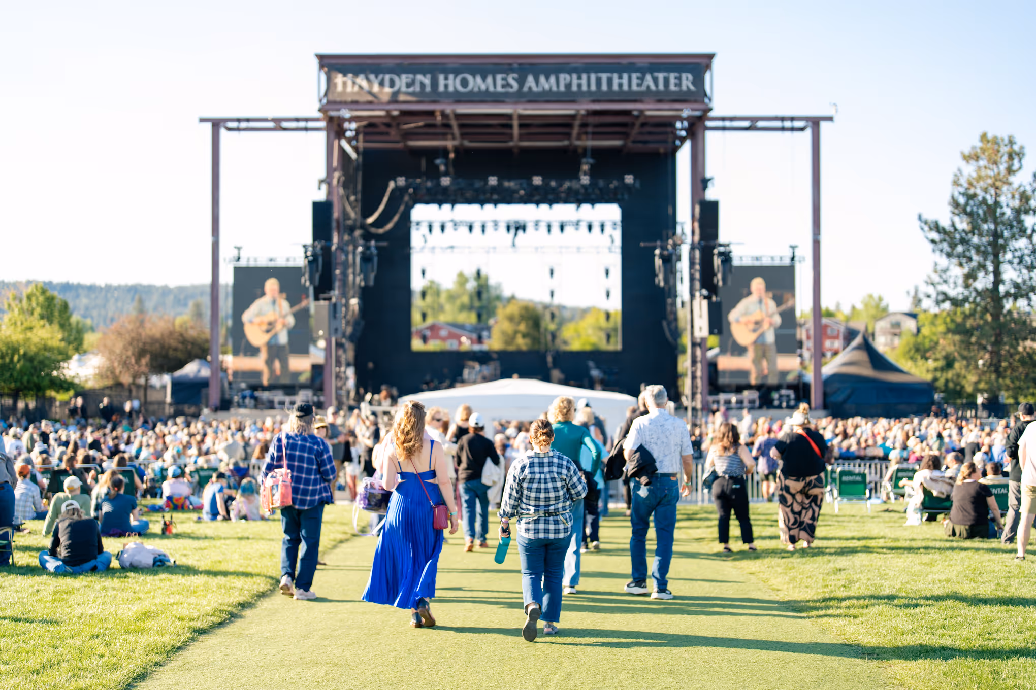 View of Hayden Homes Amphitheater stage in Bend, Oregon with fans approaching the stage.