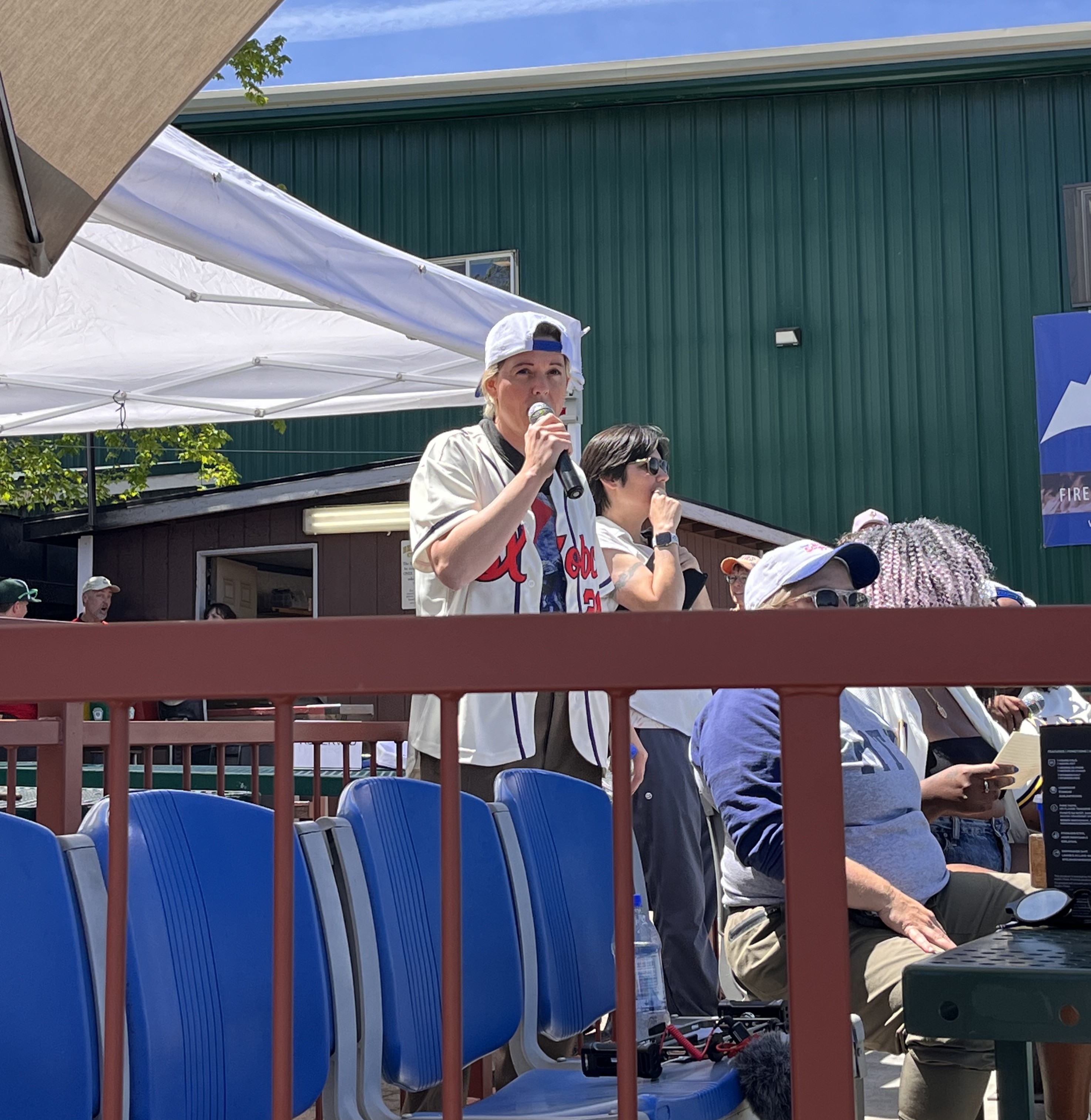 Brandi Carlile announcing community baseball game at Vince Genna Stadium in Bend, Oregon.