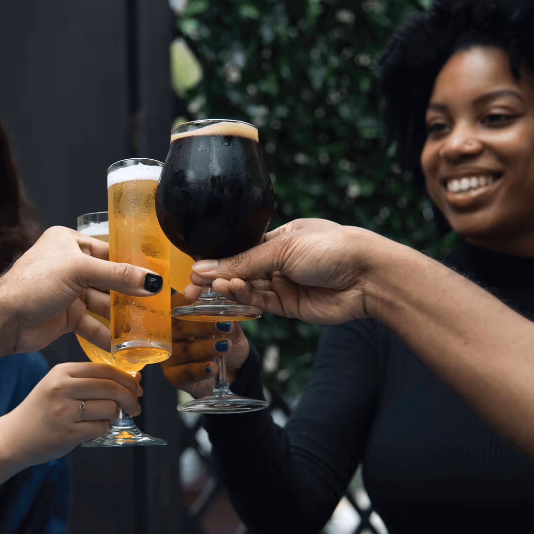 Group of people toasting with glasses of beer