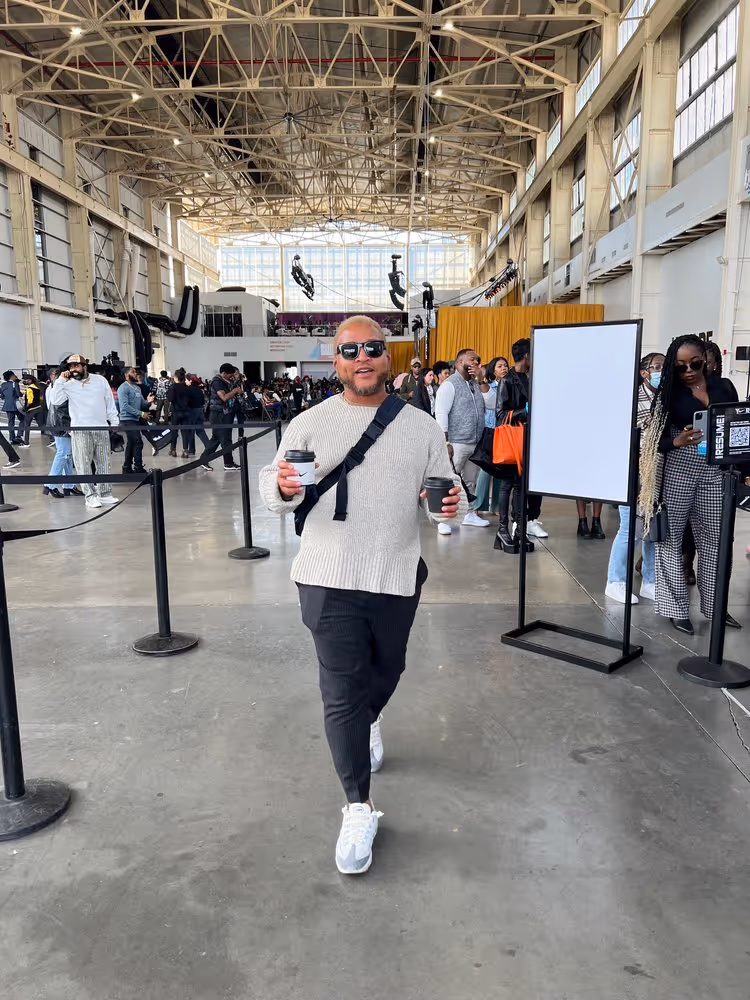 A man walking through CultureCon 2022 with a drink in hand
