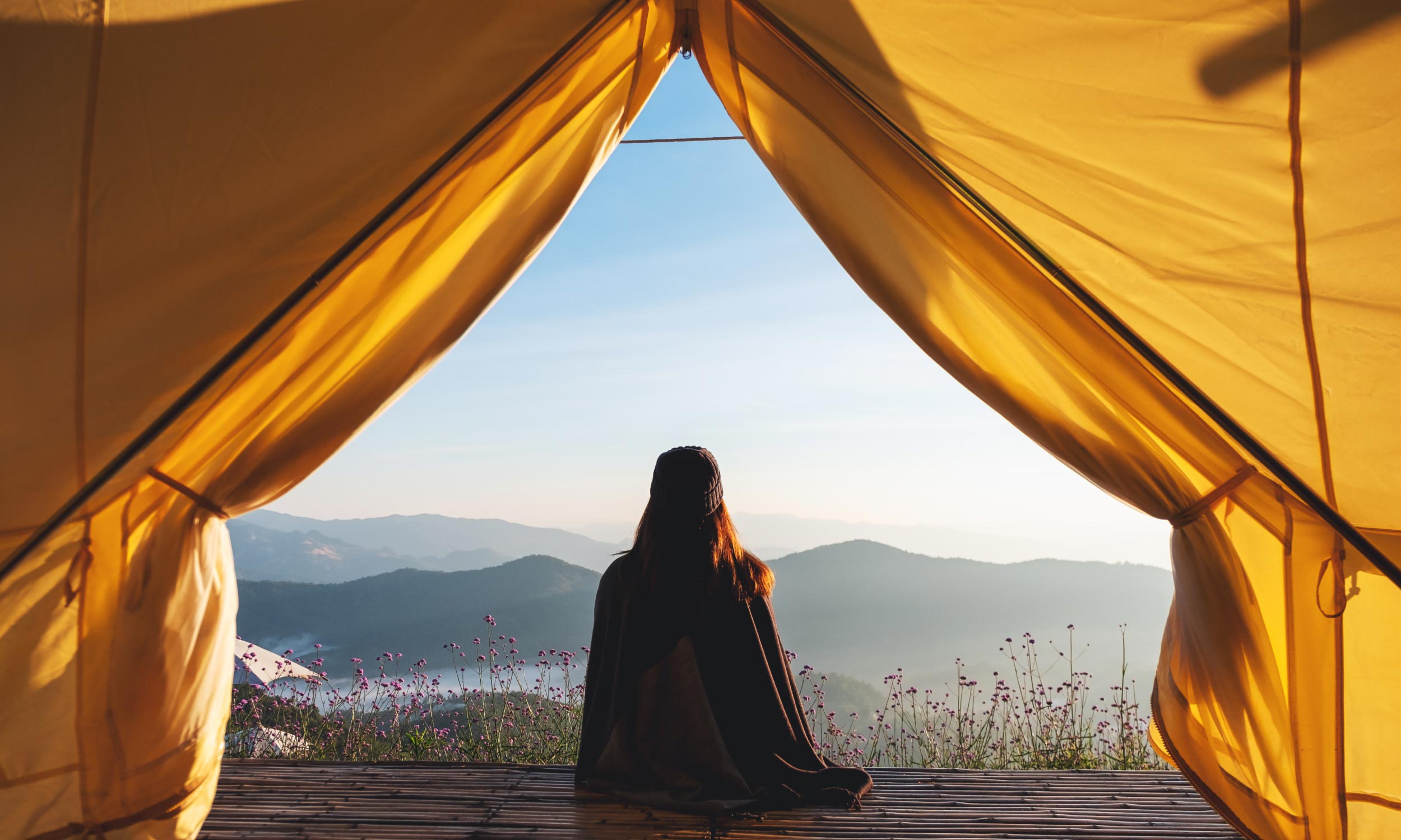 Looking out airplane window at the wing and cloudy sky