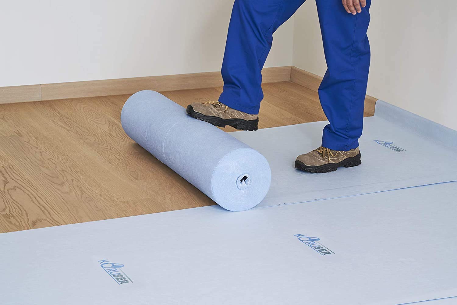 Painter laying down floor protection in a living room