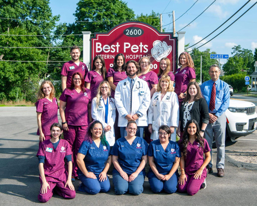 Best Pets staff standing in front of the clinic sign outside. 