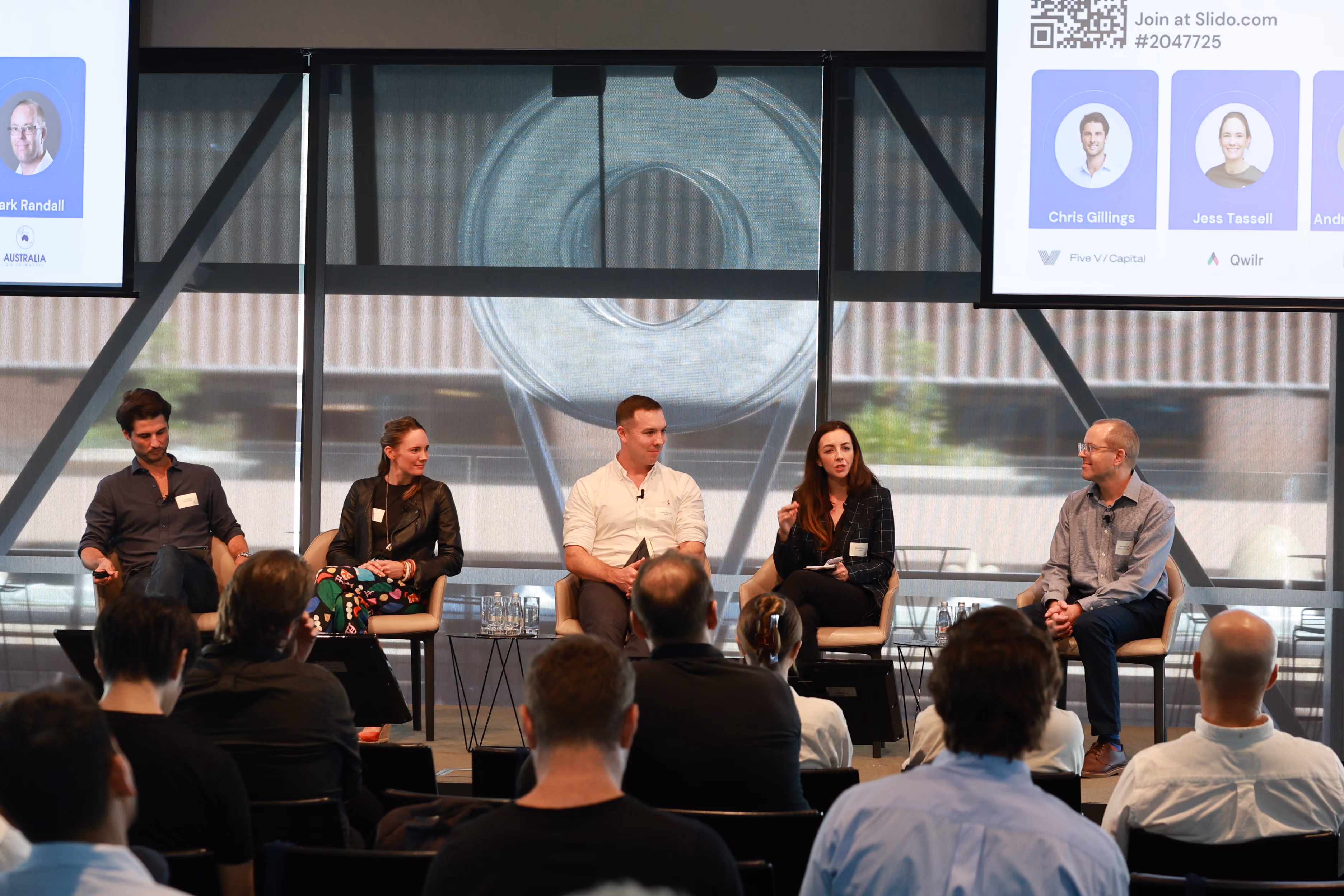 Panelists talking on stage