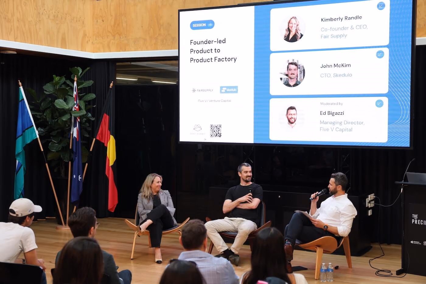 Panelists talking on stage