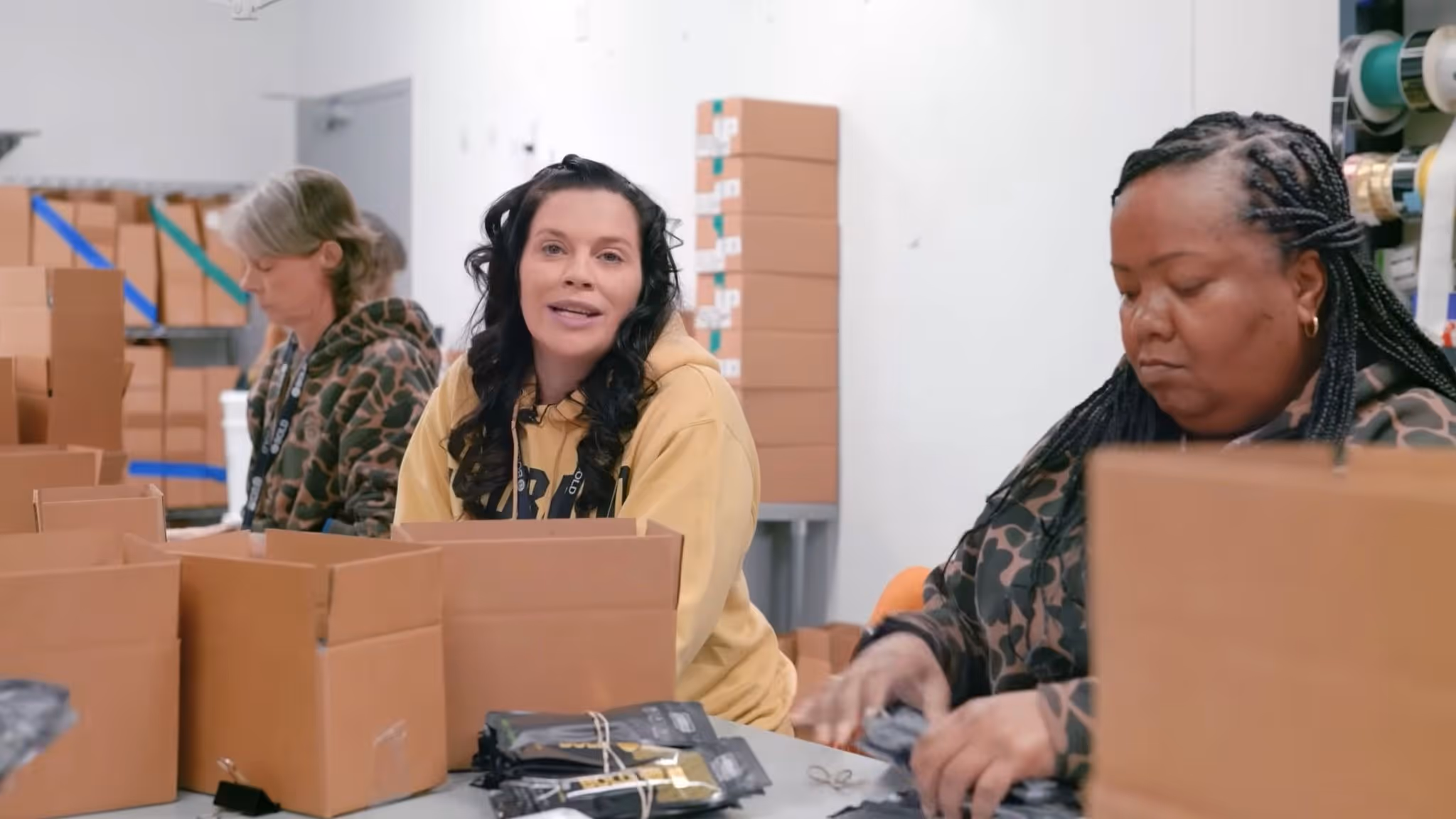 Annie Iselin Senior Director of Operations with female employees packaging cannabis products at BOLD Team facility women in Arkansas cannabis industry Roots and Reefer documentary.