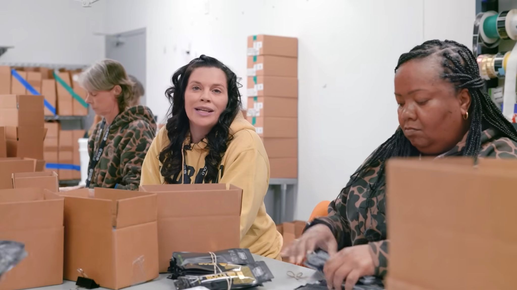 Annie Iselin Senior Director of Operations with female employees packaging cannabis products at BOLD Team facility women in Arkansas cannabis industry Roots and Reefer documentary.