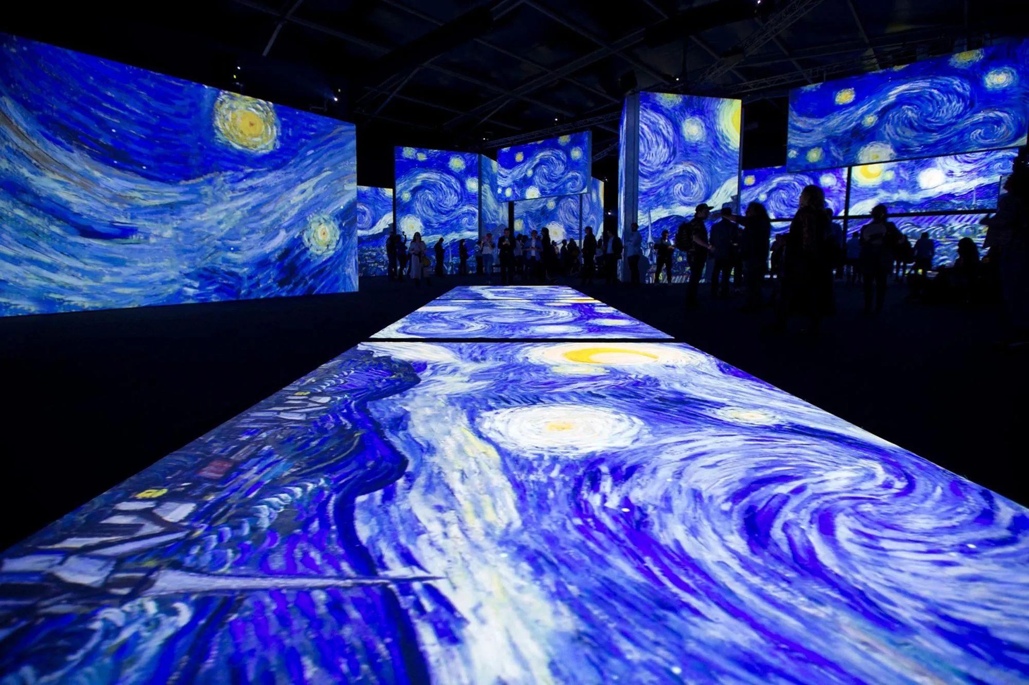 Immersive experience — three visitors inside a stunning digital art installation
