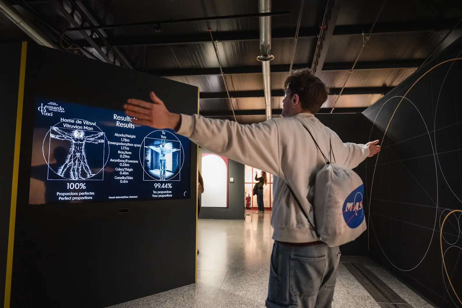 Teenager interacting with Vitruvian Man display