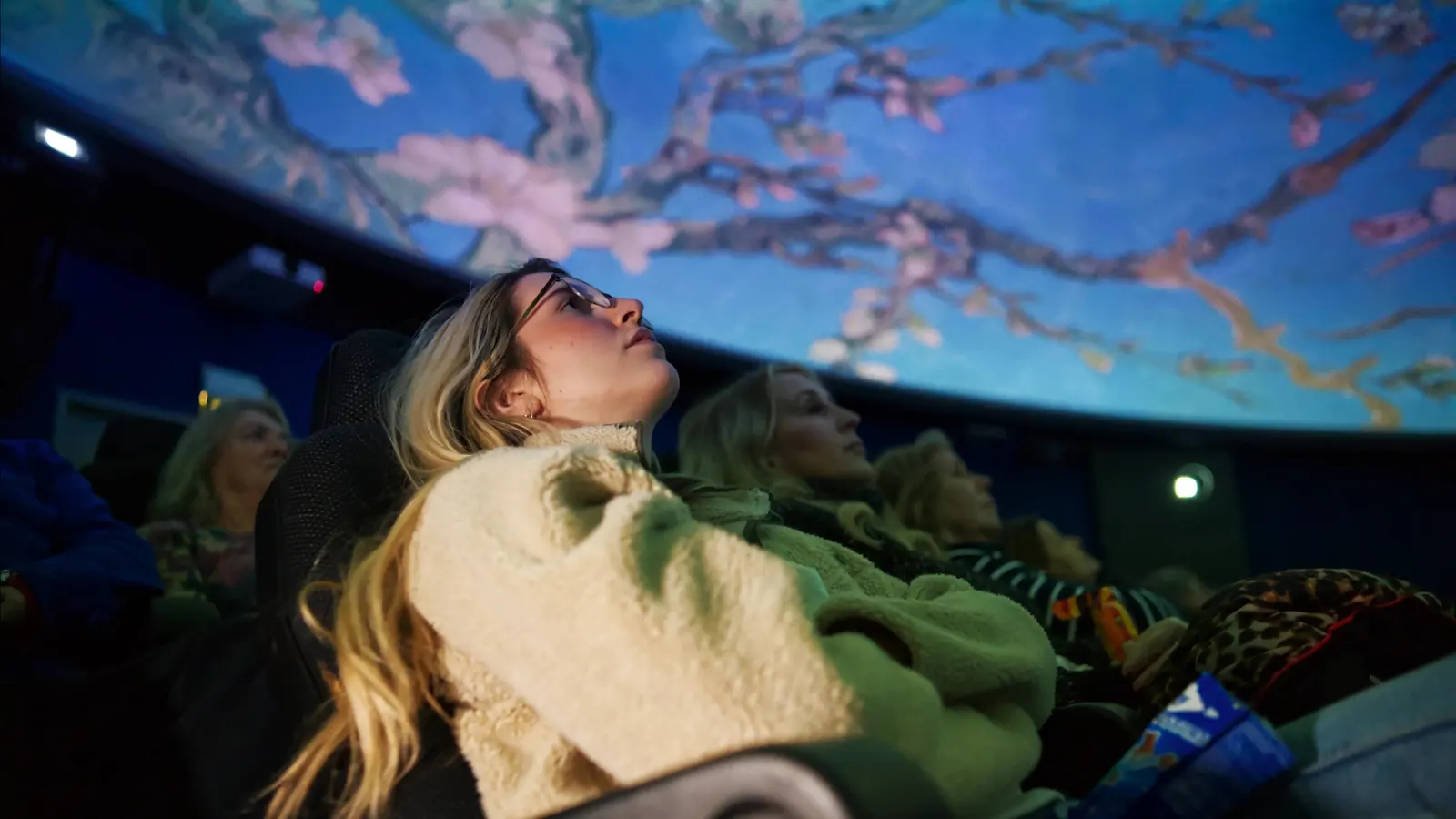 Female in planetarium enjoying Van Gogh Alive