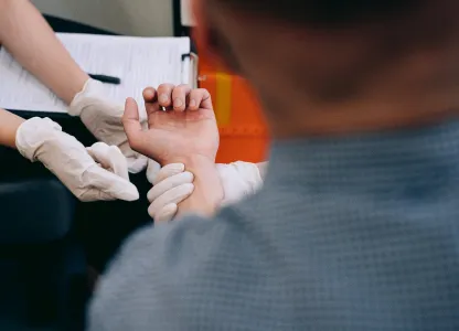 Nurse extracting blood on a man's arm