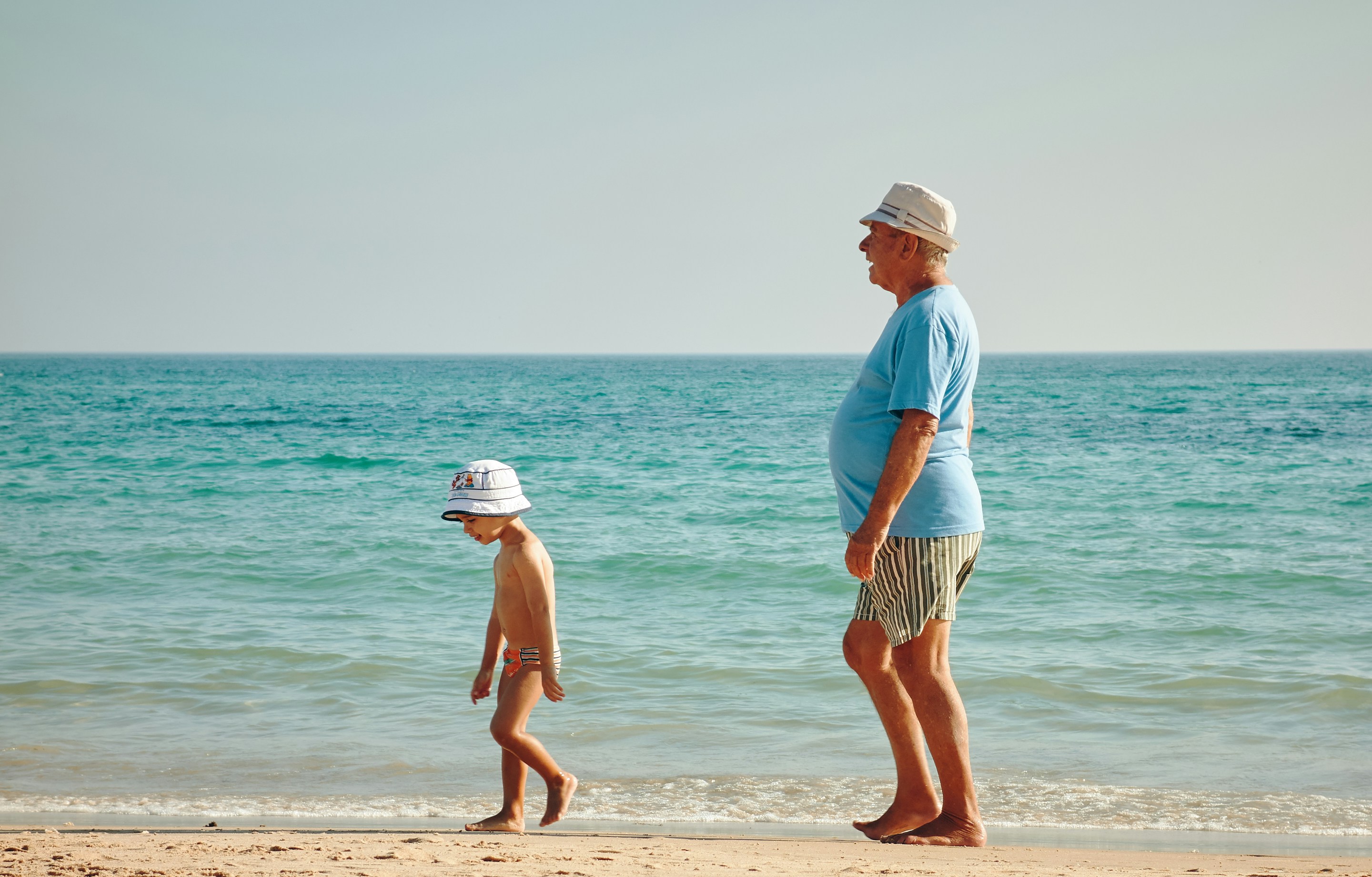 A grandparent and child at the beach