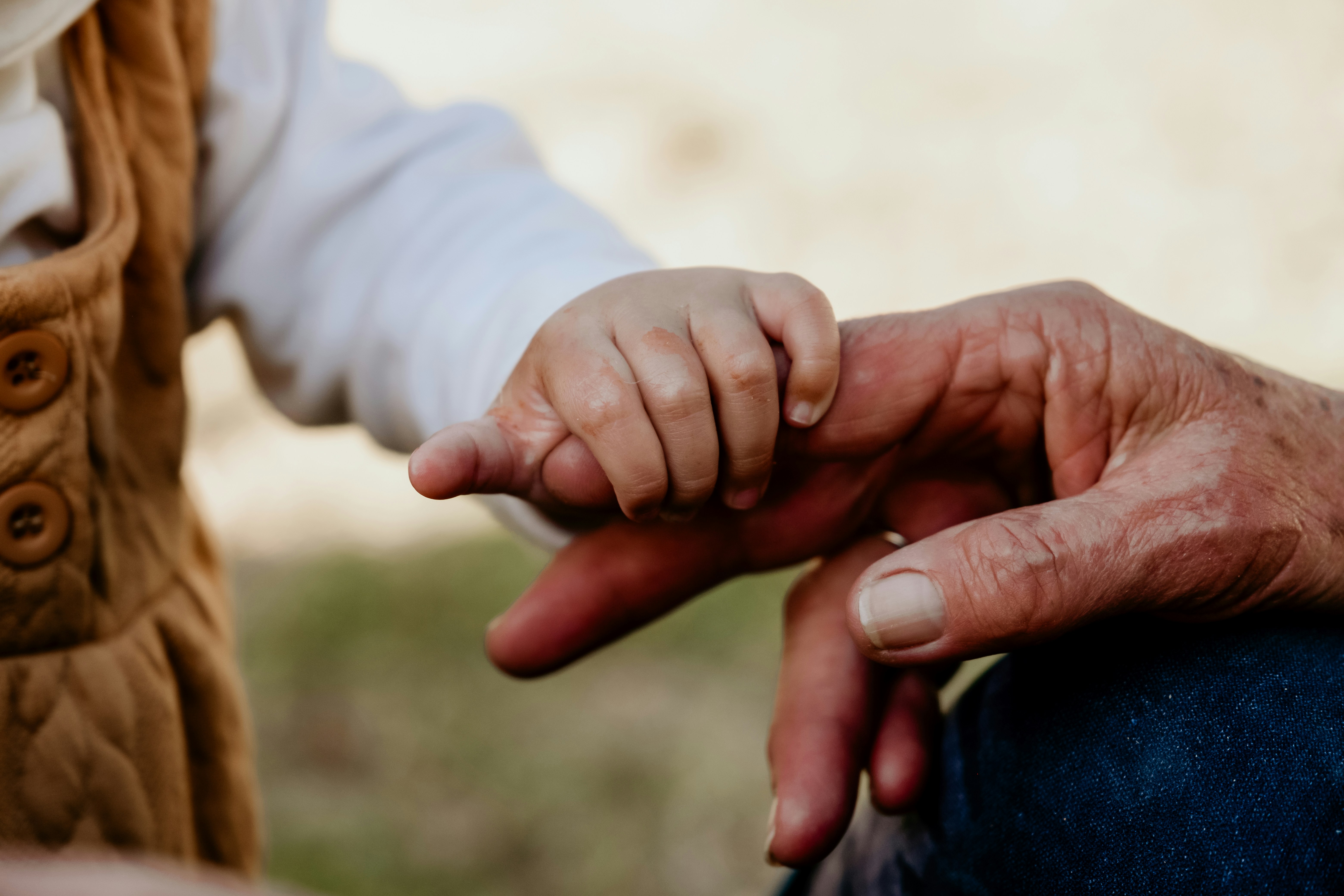 A child holding an adults hand