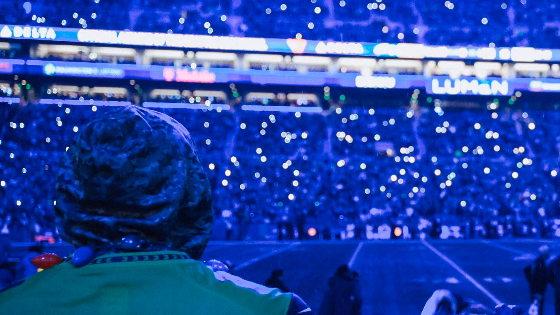 Fans participating in SEA Lights with their phone flashlights lit up.