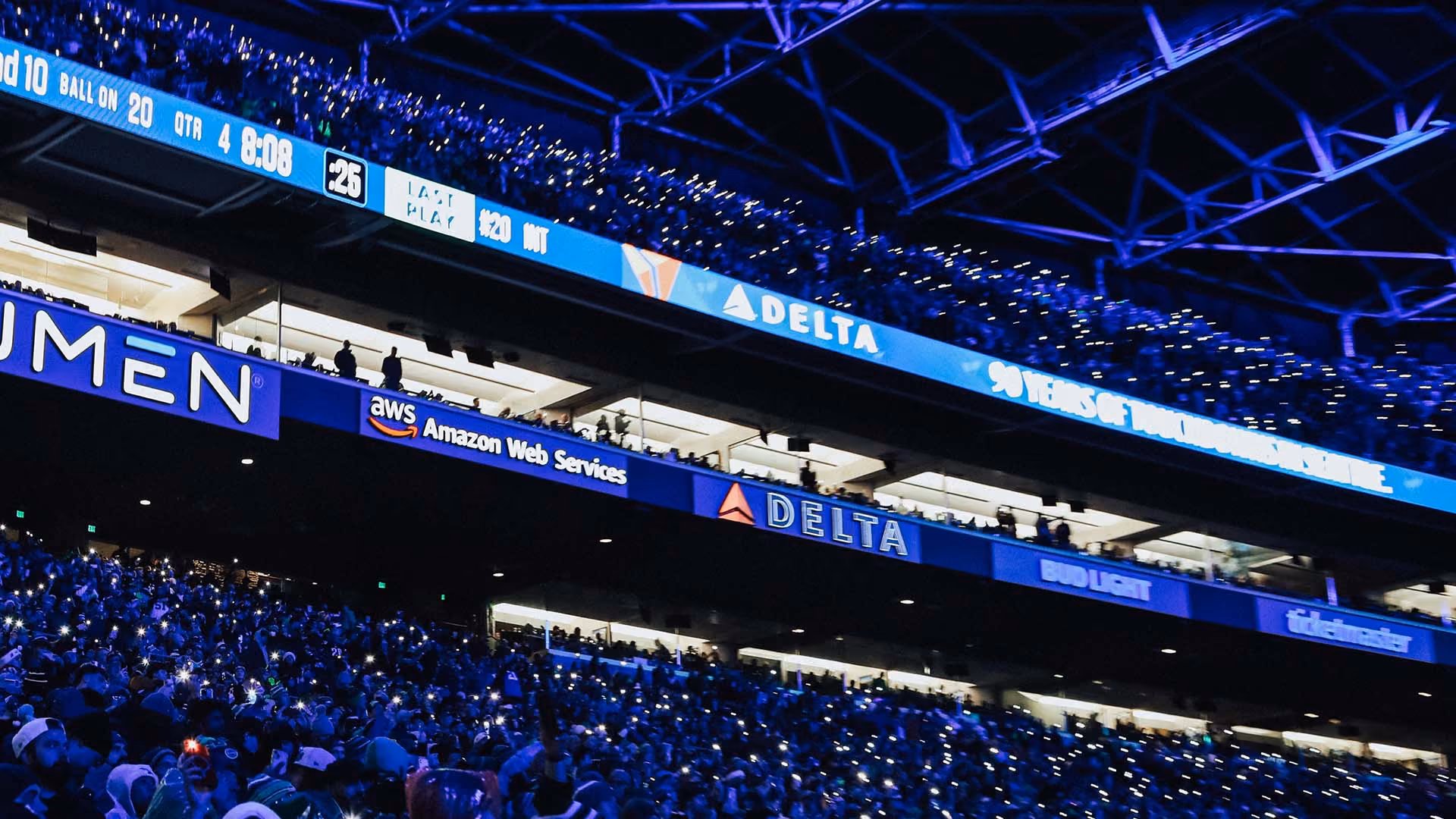 Fans participating in SEA Lights with their phone flashlights lit up.