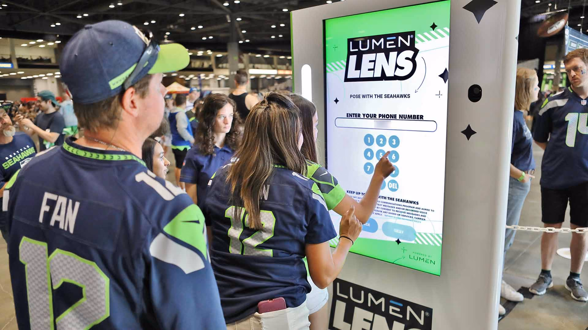 Fans using a Lumen Lens kiosk.
