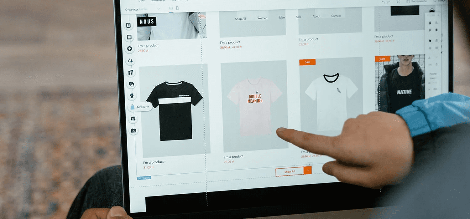  Person browsing t-shirts on a laptop -  Organic Dropshipping 