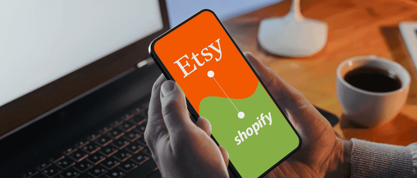 Person hand holding phone comparing Etsy and Shopify - Tips to Grow an Etsy Dropshipping Store
