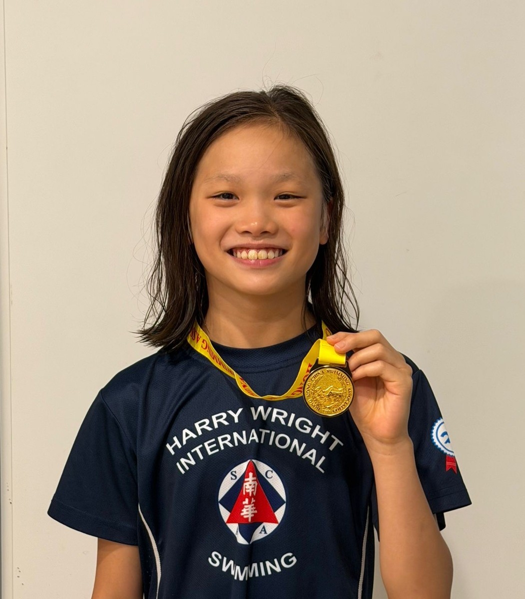 Joelle Yip Yee Kiu celebrates her 50m Breaststroke gold medal for Harry Wright Swim School at the Division 2 Part 2 Long Course meet in Kwun Tong, Hong Kong