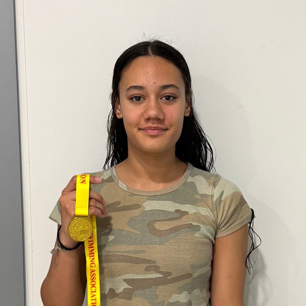 Knecht Ilithya celebrates her double gold in the 200m IM and 50m Breaststroke for Harry Wright Swim School at the Division 2 Part 2 Long Course meet in Kwun Tong, Hong Kong