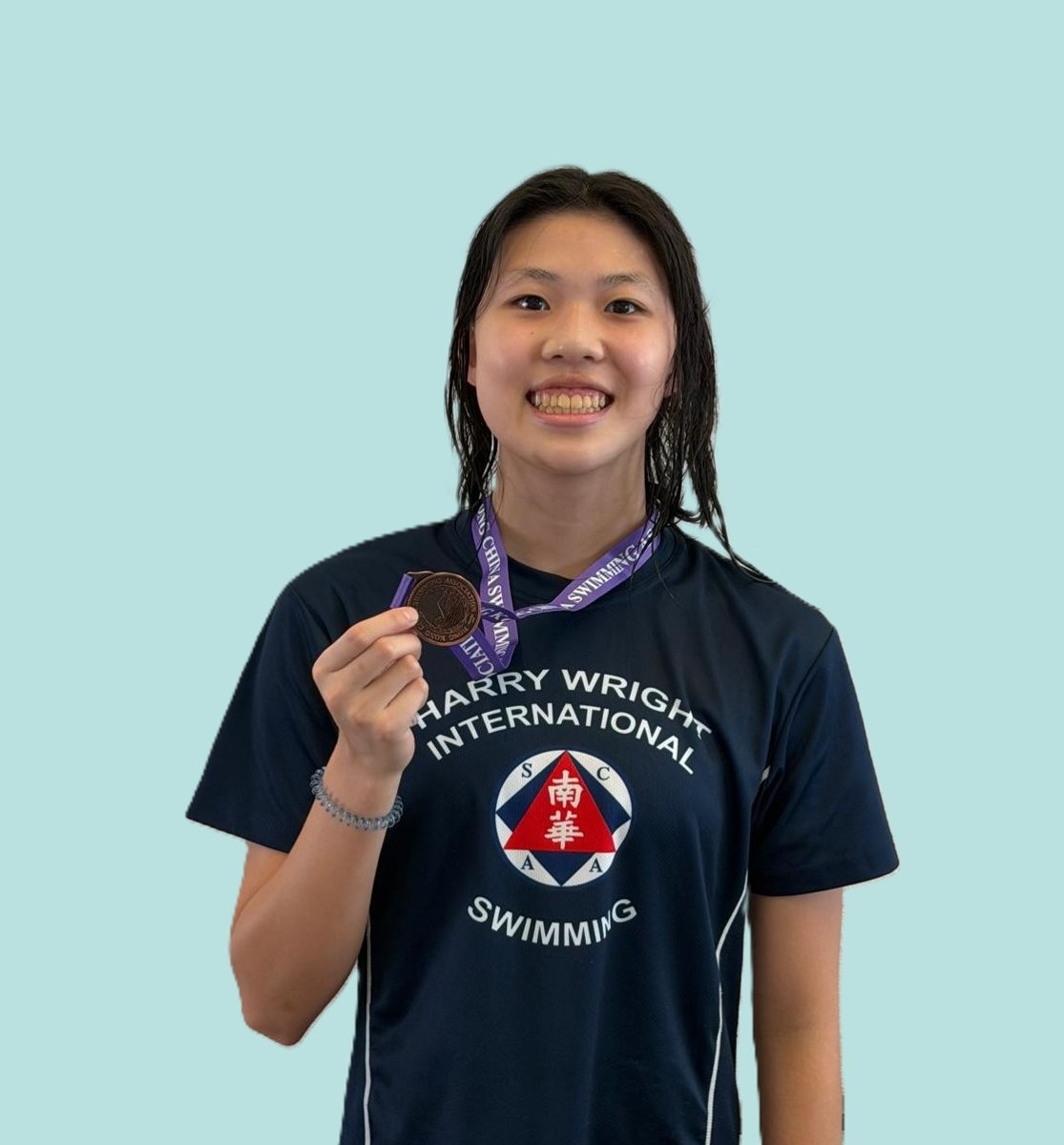 Harry Wright Swim School swimmer holding up a medal at the Division 3 Part 3 Long Course Age Group Competition, Hong Kong