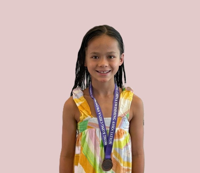 Harry Wright Swim School medallist with her medal at the Division 3 Part 3 Long Course Age Group Competition, Hong Kong