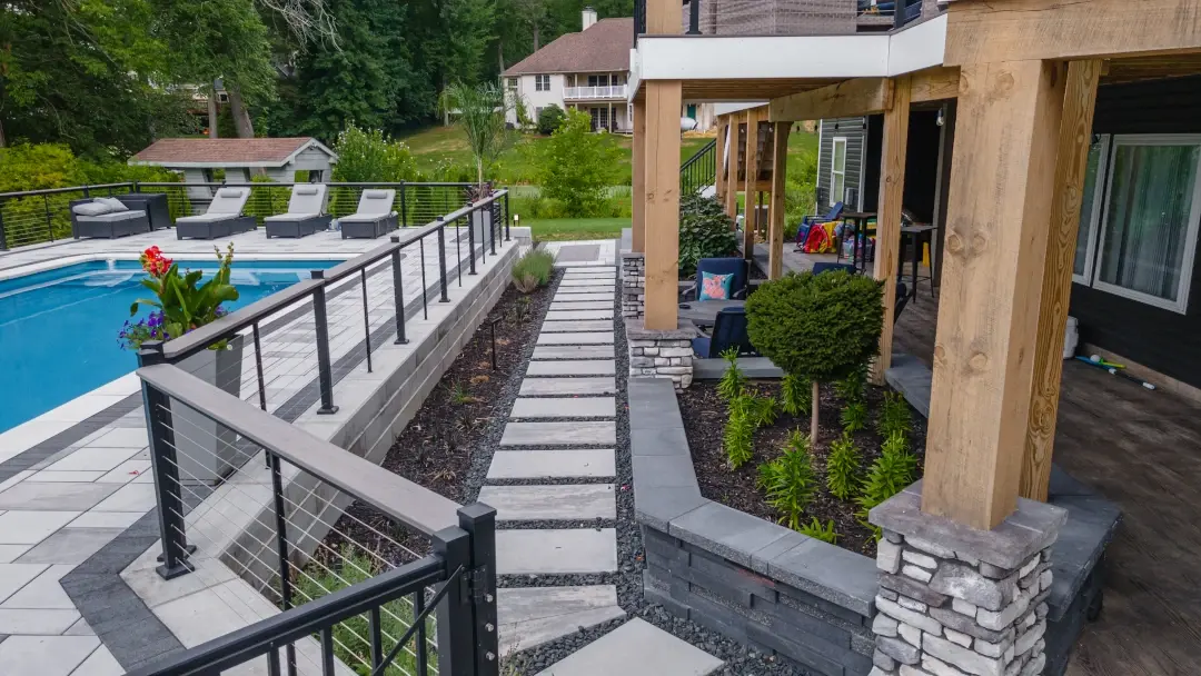 backyard paver walkway between pool and house