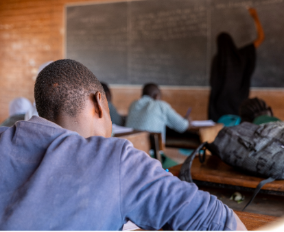 A person sitting at a desk in a classroomAI-generated content may be incorrect.