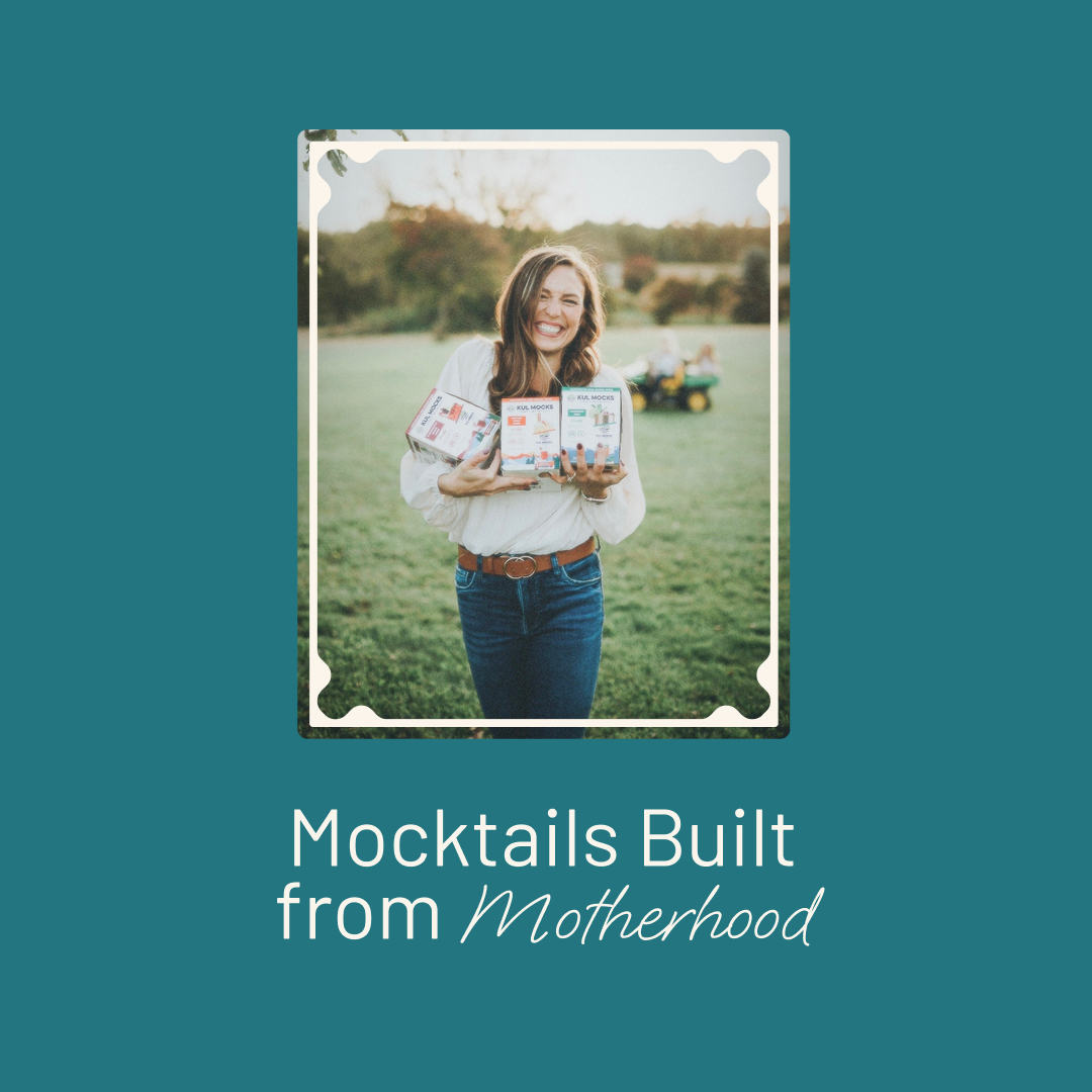 Smiling woman outdoors holding three boxed Kul Mocks mocktail kits with greenery and children in background.