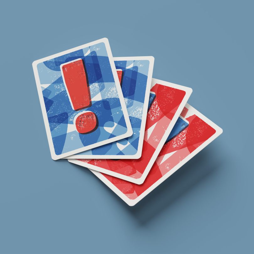 A stack of game cards with blue backs showing a red exclamation mark and red backs with abstract designs.