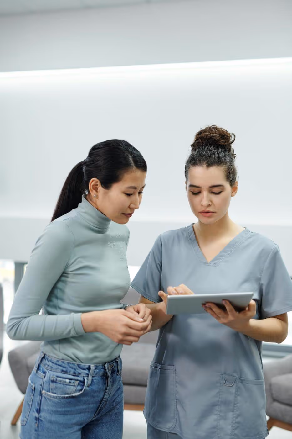 Nurse and another woman looking at a tablet together